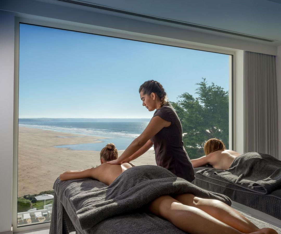 massage therapist working at the Source Spa at Saunton Sands Hotel with beach in background