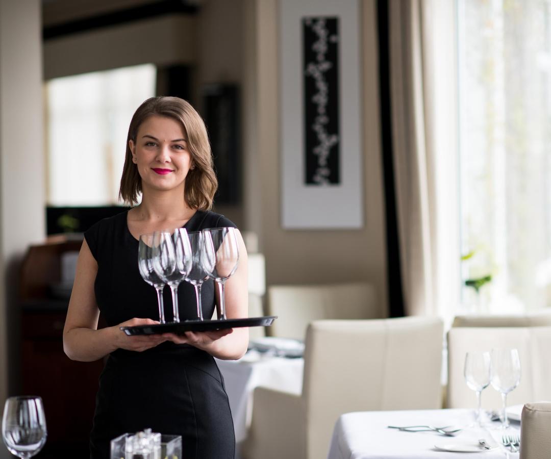 Waitress carrying drinks tray at the Carlyon Bay Hotel in Cornwall