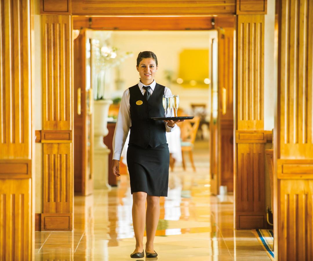 Waitress carrying drinks at The Saunton Sands Hotel North Devon