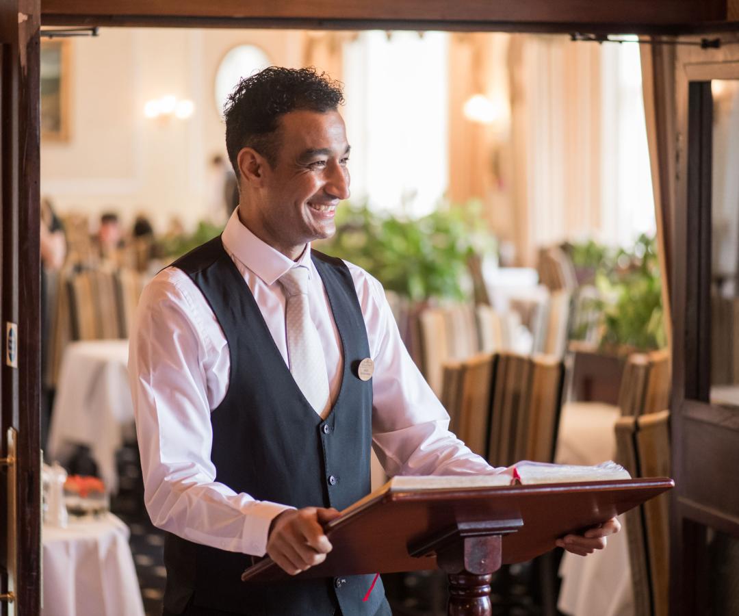 Restaurant manager welcoming guests