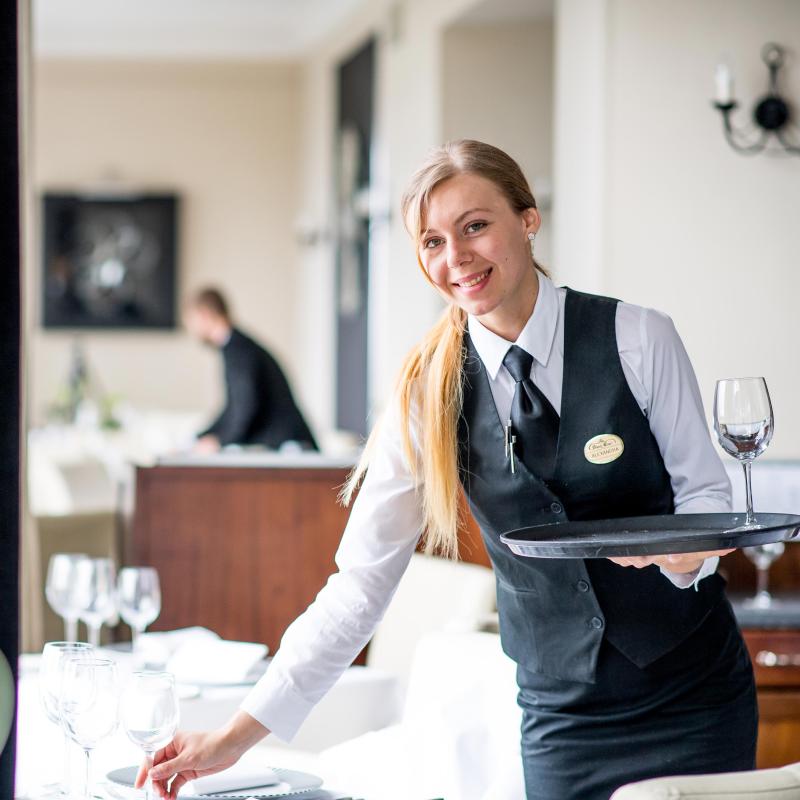 Waitress at work setting tables at the Carlyon Bay Hotel in Cornwall
