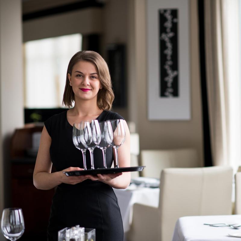 Waitress carrying drinks tray at the Carlyon Bay Hotel in Cornwall