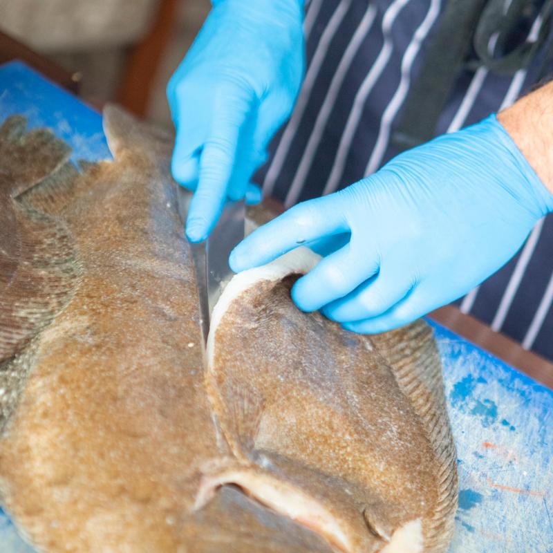 Chef preparing fish in the kitchen of the Royal Duchy Hotel