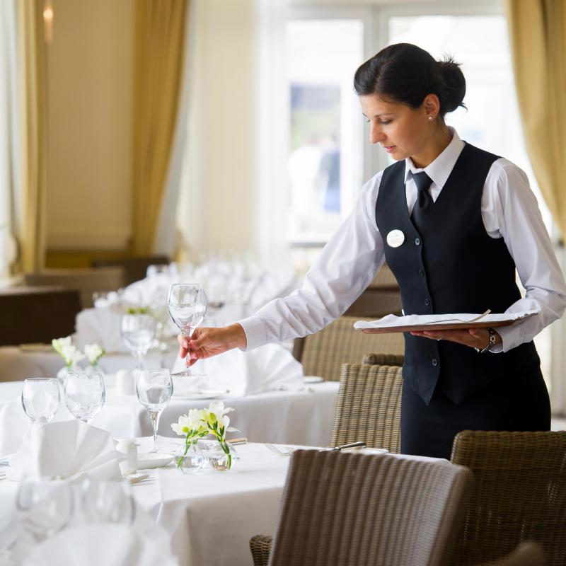 Waitress setting tables at The Saunton Sands Hotel North Devon