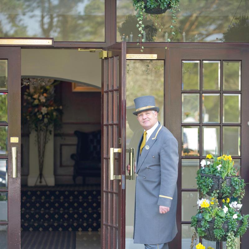 Porter opening door at the Carlyon Bay Hotel in Cornwall